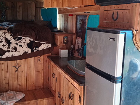 Cabinet, sink and refrigerator in a living quarters conversion