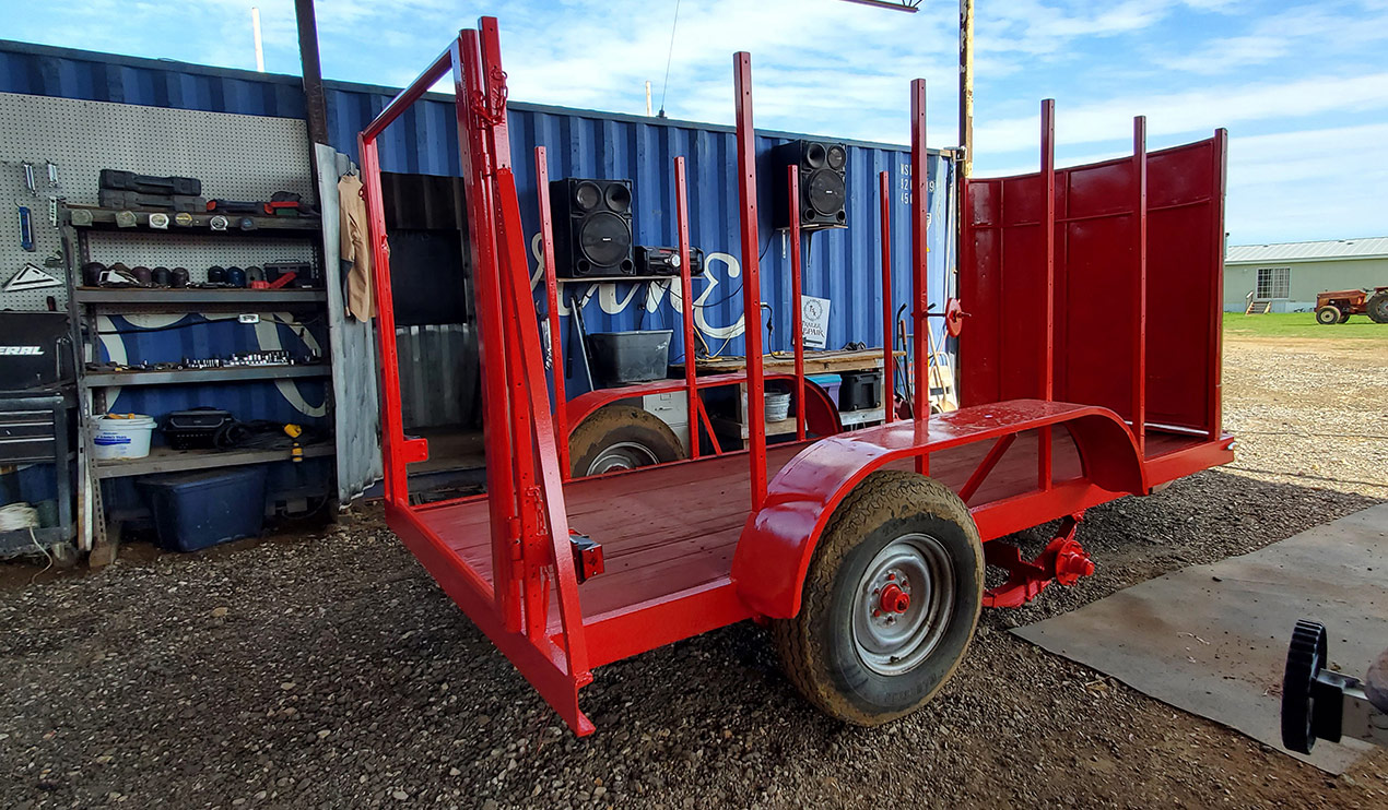 red vintage trailer that's been painted, needs wood panels added