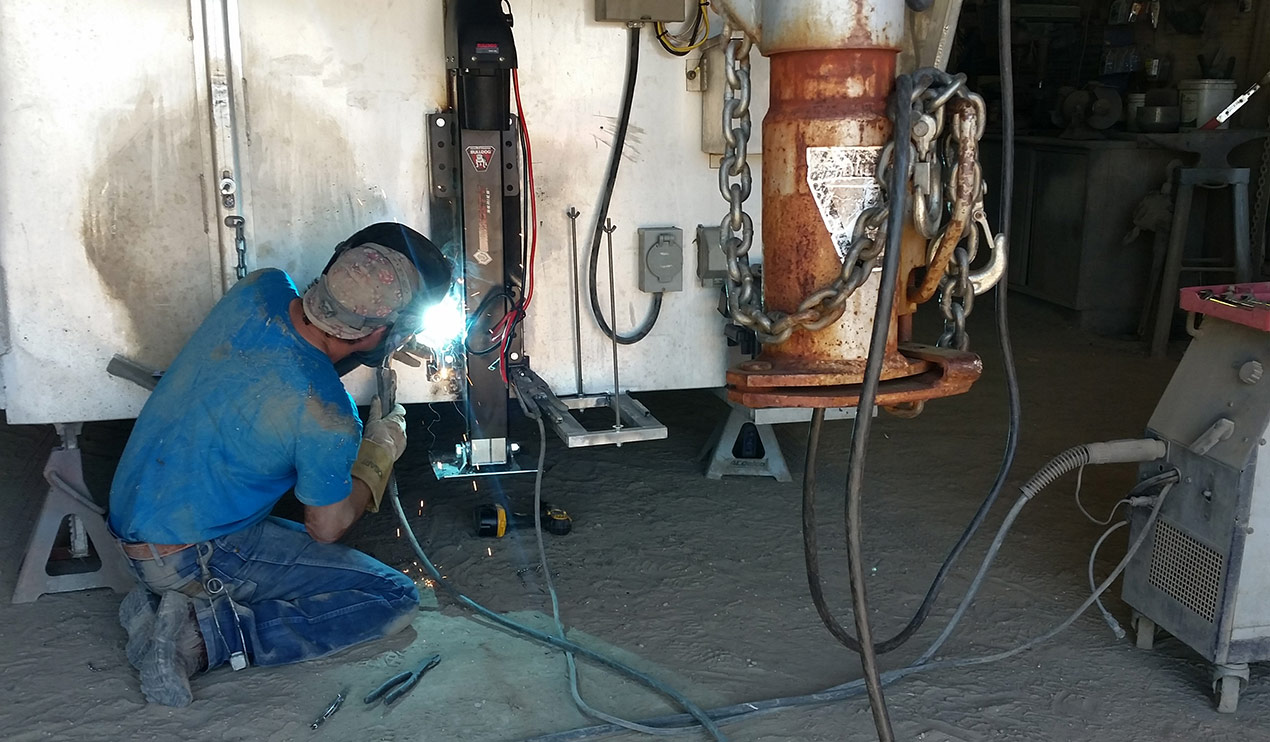 Steve Heald welding an electric jack to aluminum trailer