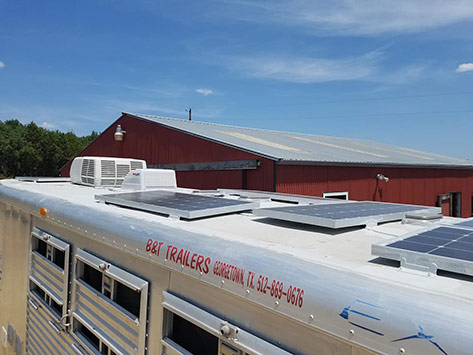 solar panels, rubber roofing, air conditioner and fan cover on trailer roof